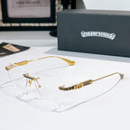 Silver-rimmed eyeglasses with clear lenses and gold patterned temple arms