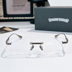 Silver-rimmed eyeglasses with clear lenses and patterned metal temple arms