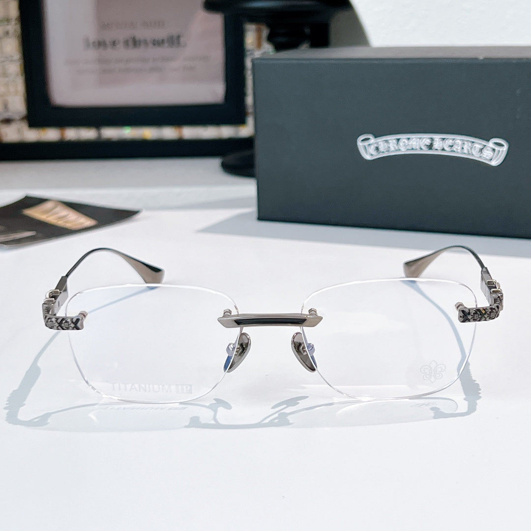 Silver-rimmed eyeglasses with clear lenses and patterned metal temple arms