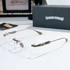 Clear-lensed eyeglasses with silver frame and patterned black temple arms