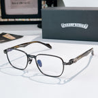 Eyeglasses with dark frame, clear lenses, and brown patterned temples.