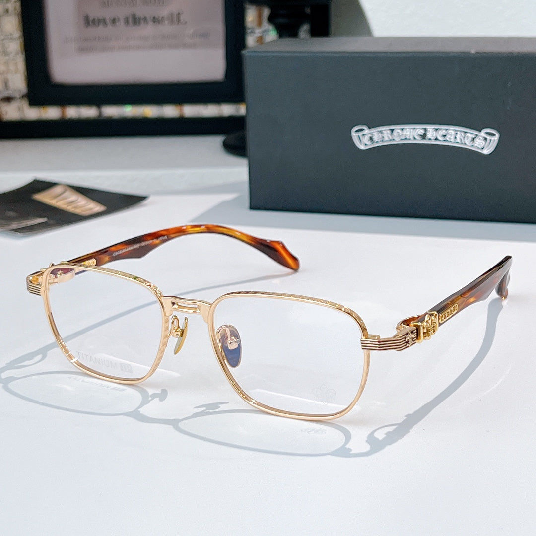 Eyeglasses with gold rectangular frame and orange-brown patterned temples.