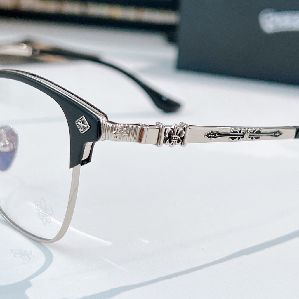 Close-up of silver eyeglasses hinge and bridge with patterned temple arms