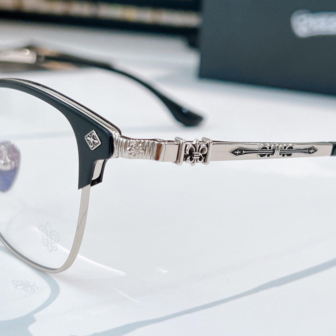 Close-up of silver eyeglasses hinge and bridge with patterned temple arms