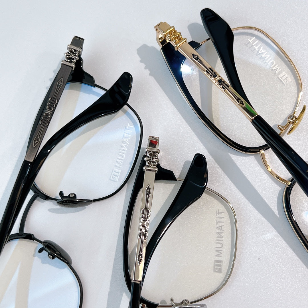 Assorted eyeglasses with black and gold frames, blue-tinted lenses, clear lenses