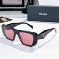 Prada sunglasses with dark frames and pink tinted lenses
