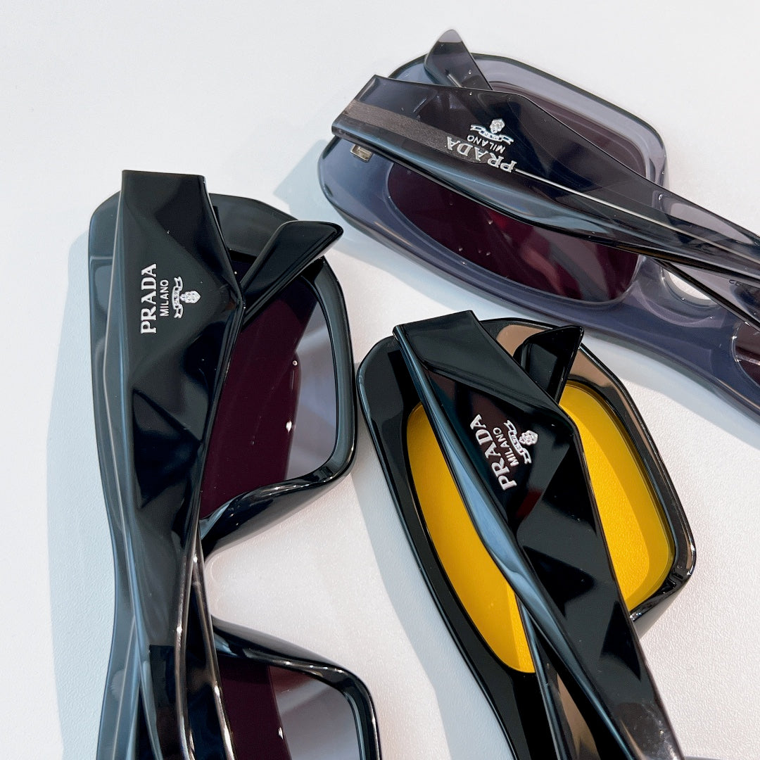 Prada sunglasses with assorted frames and tinted lenses, stacked