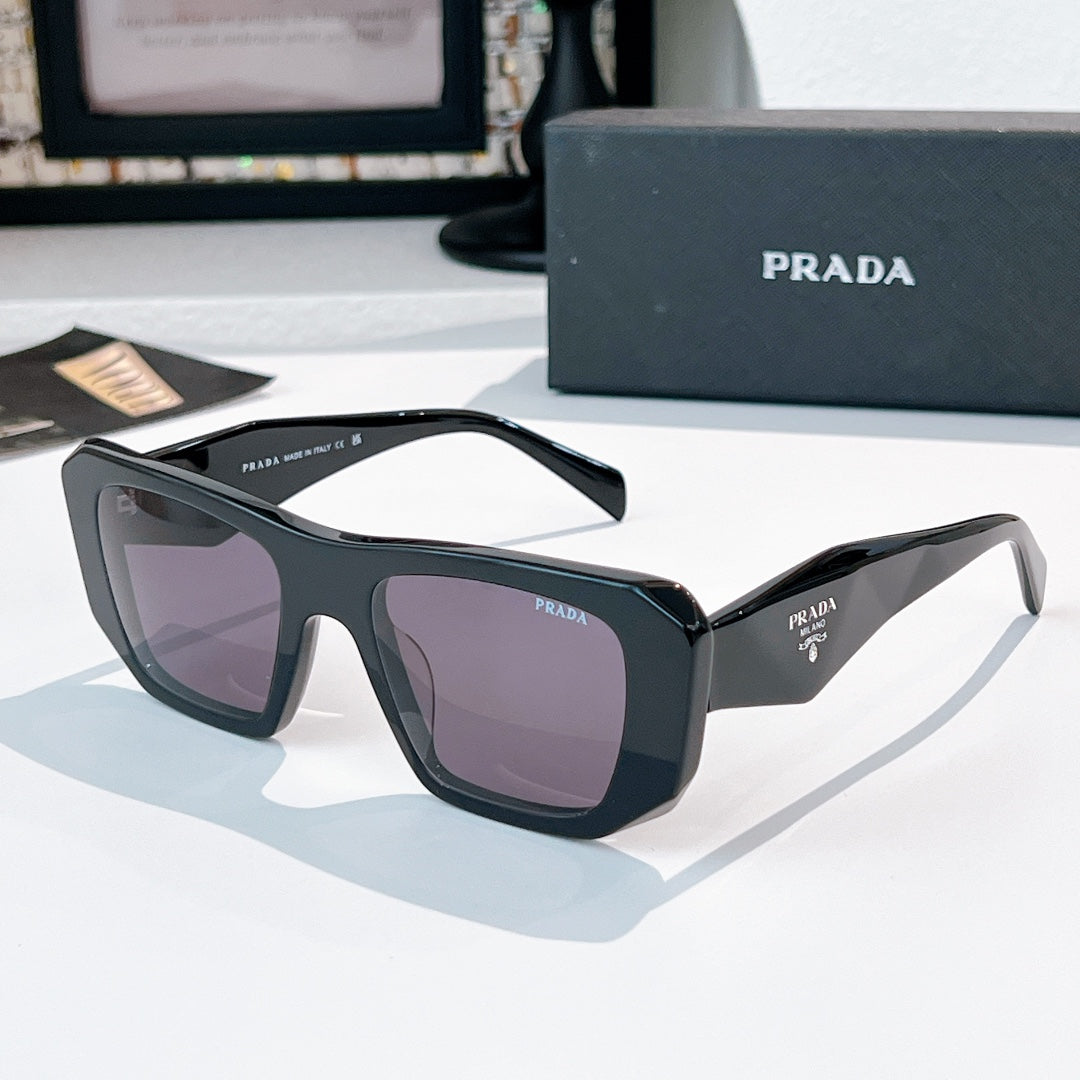 Prada sunglasses with dark frames and mauve tinted lenses