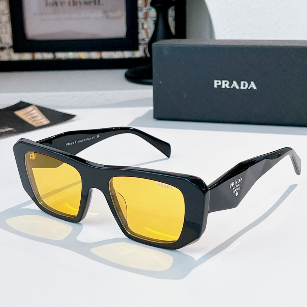 Prada sunglasses with black frames and yellow tinted lenses