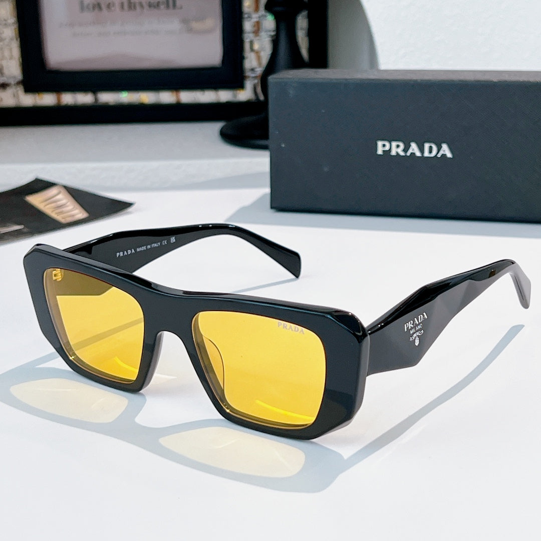 Prada sunglasses with black frames and yellow tinted lenses