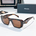 Prada sunglasses with dark frames and warm brown tinted lenses