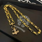 Gold chain necklace set with cross pendants on gift box