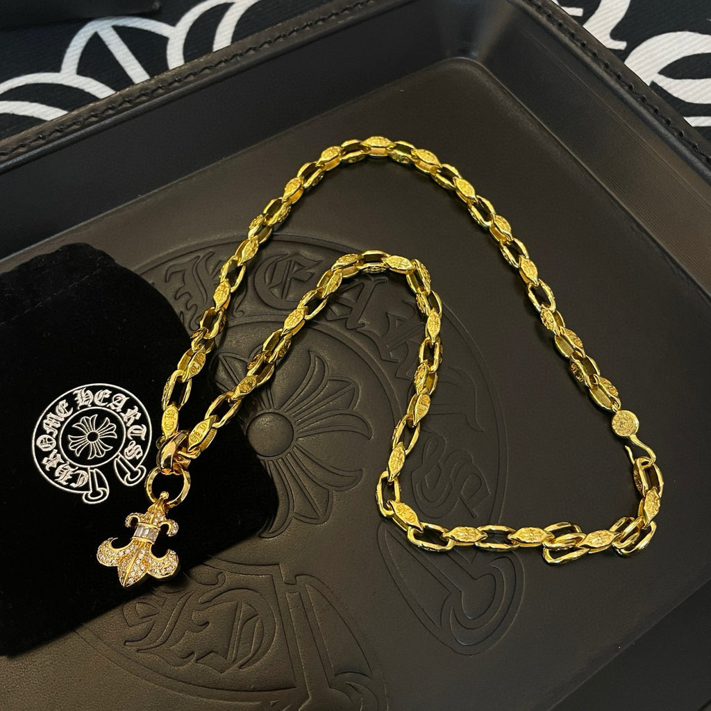 Gold chain necklace with cross charm on branded gift box