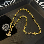 Gold chain necklace with cross charm on branded gift box