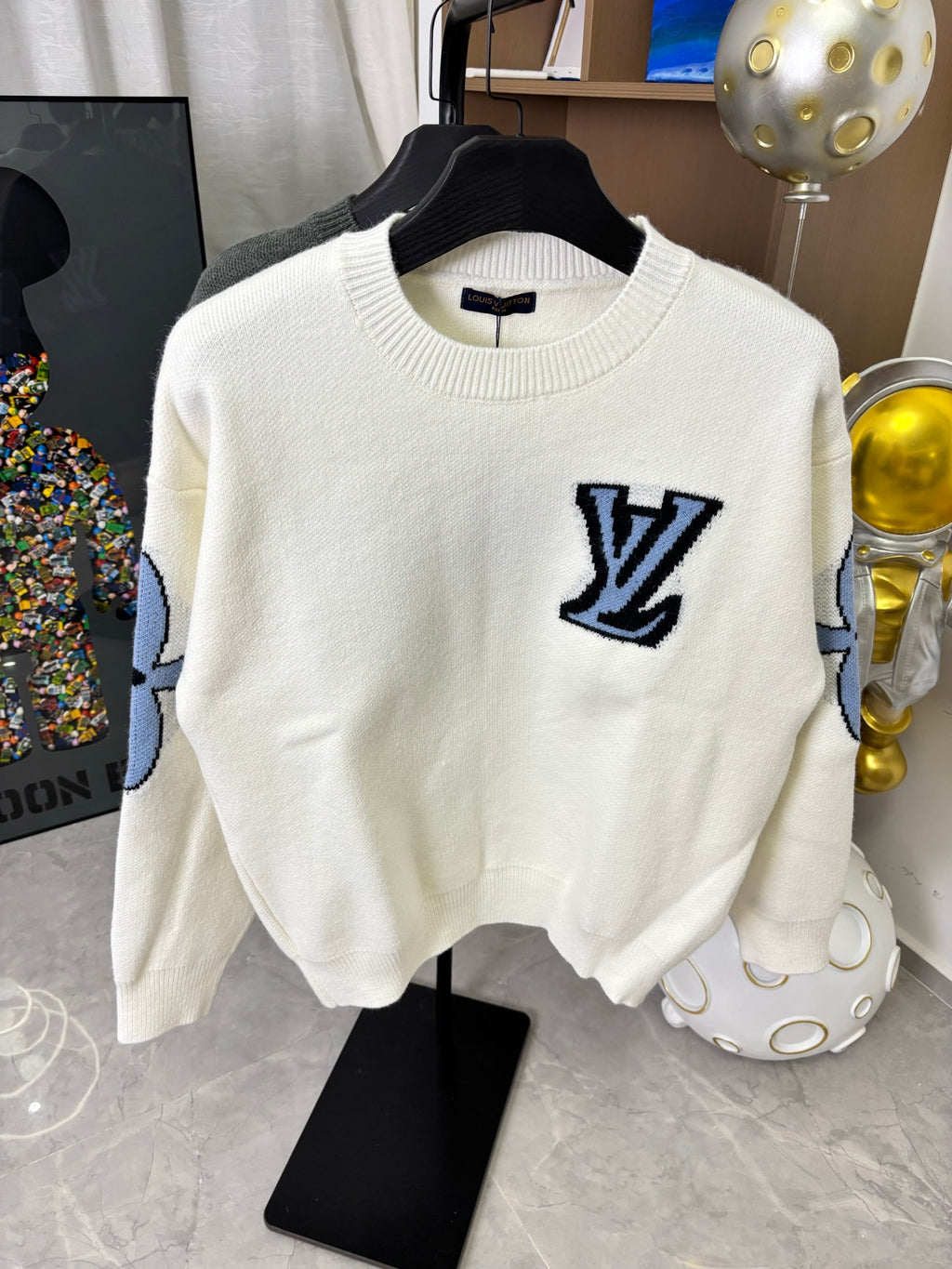 Off-white knit sweater with navy LV logo patch