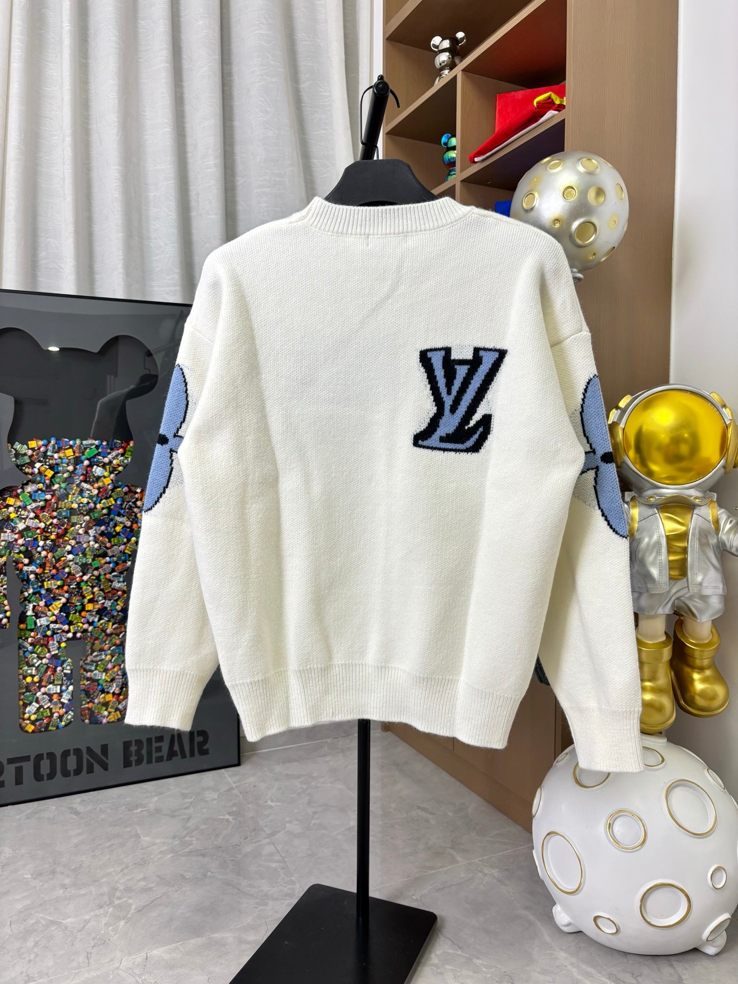 Off-white knit sweater with navy LV logo on back