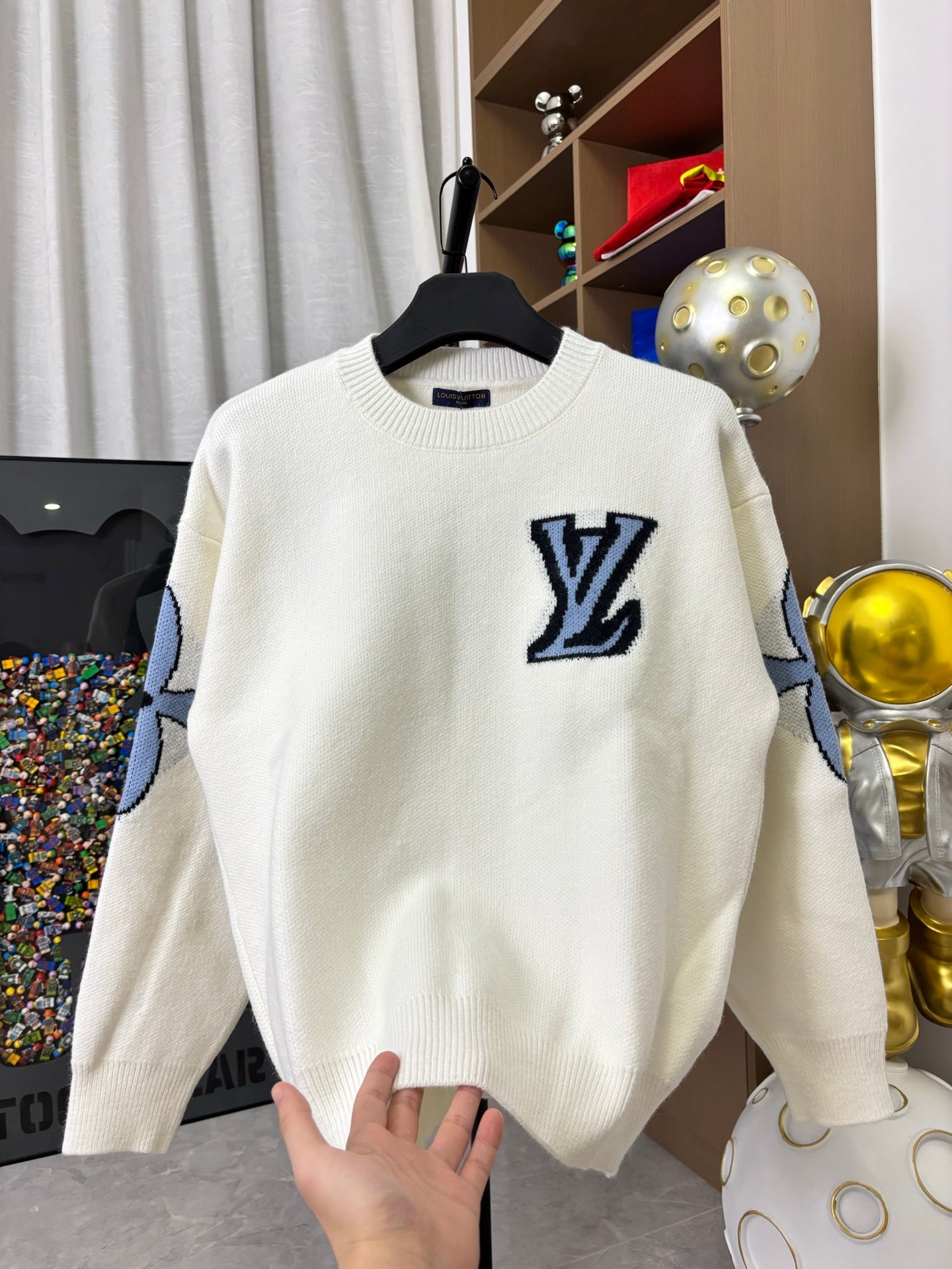 Off-white knit sweater with navy LV logo on chest