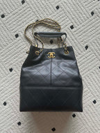 Chanel quilted leather bucket bag with gold chain handles and drawstring top
