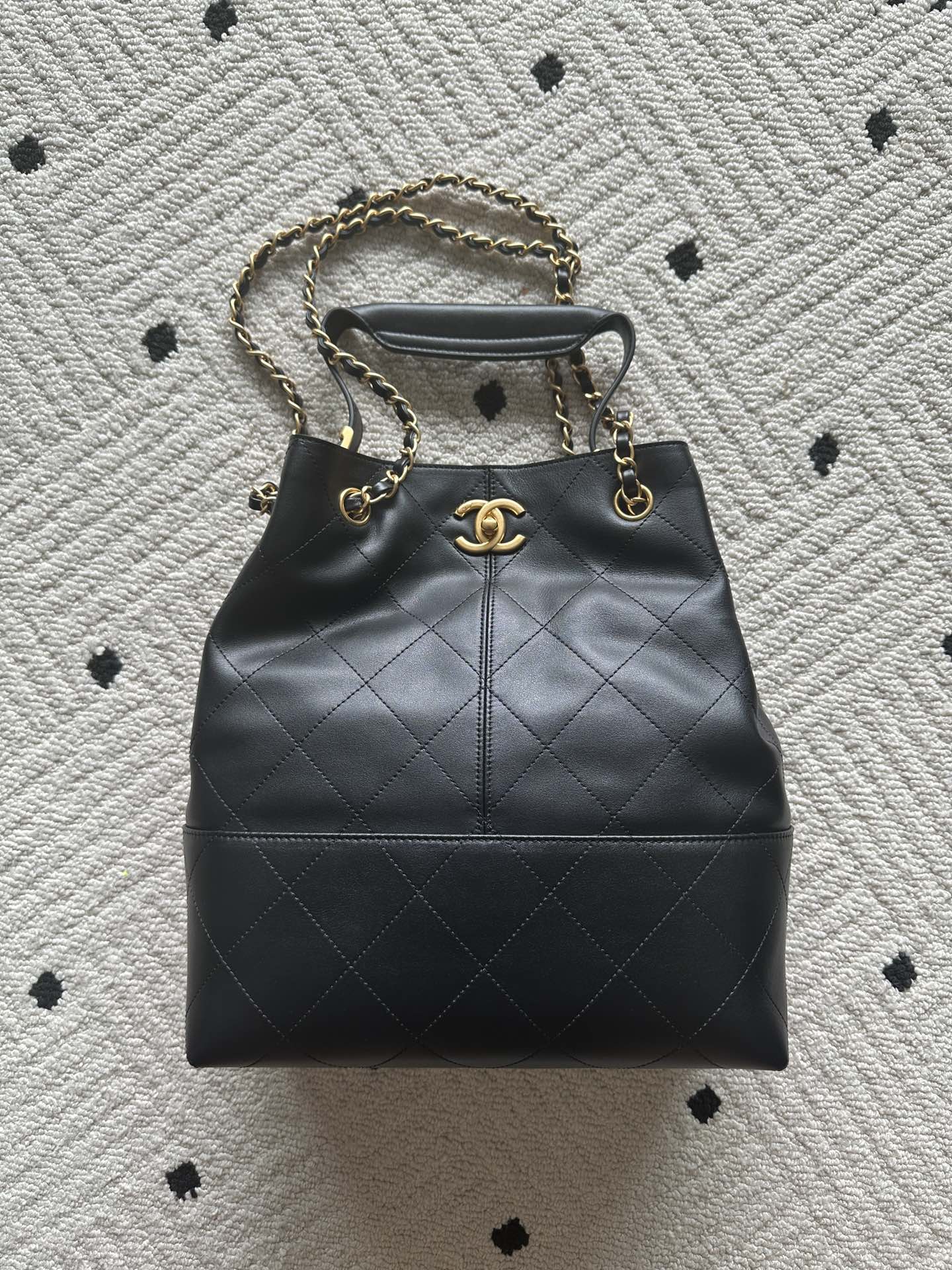 Chanel quilted leather bucket bag with gold chain handles and drawstring top