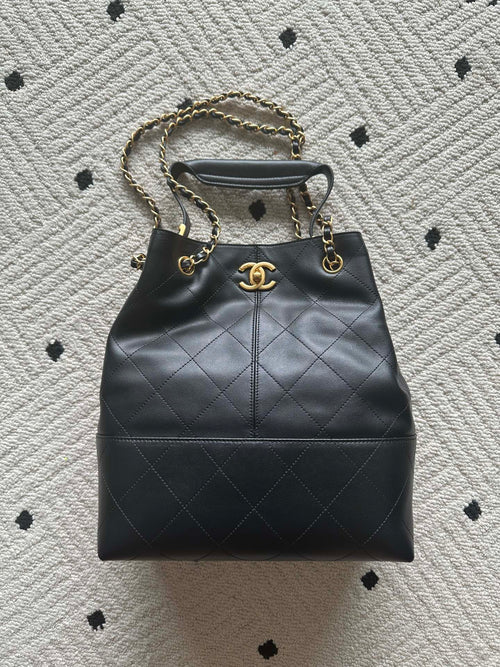 Chanel quilted leather bucket bag with gold chain handles and drawstring top
