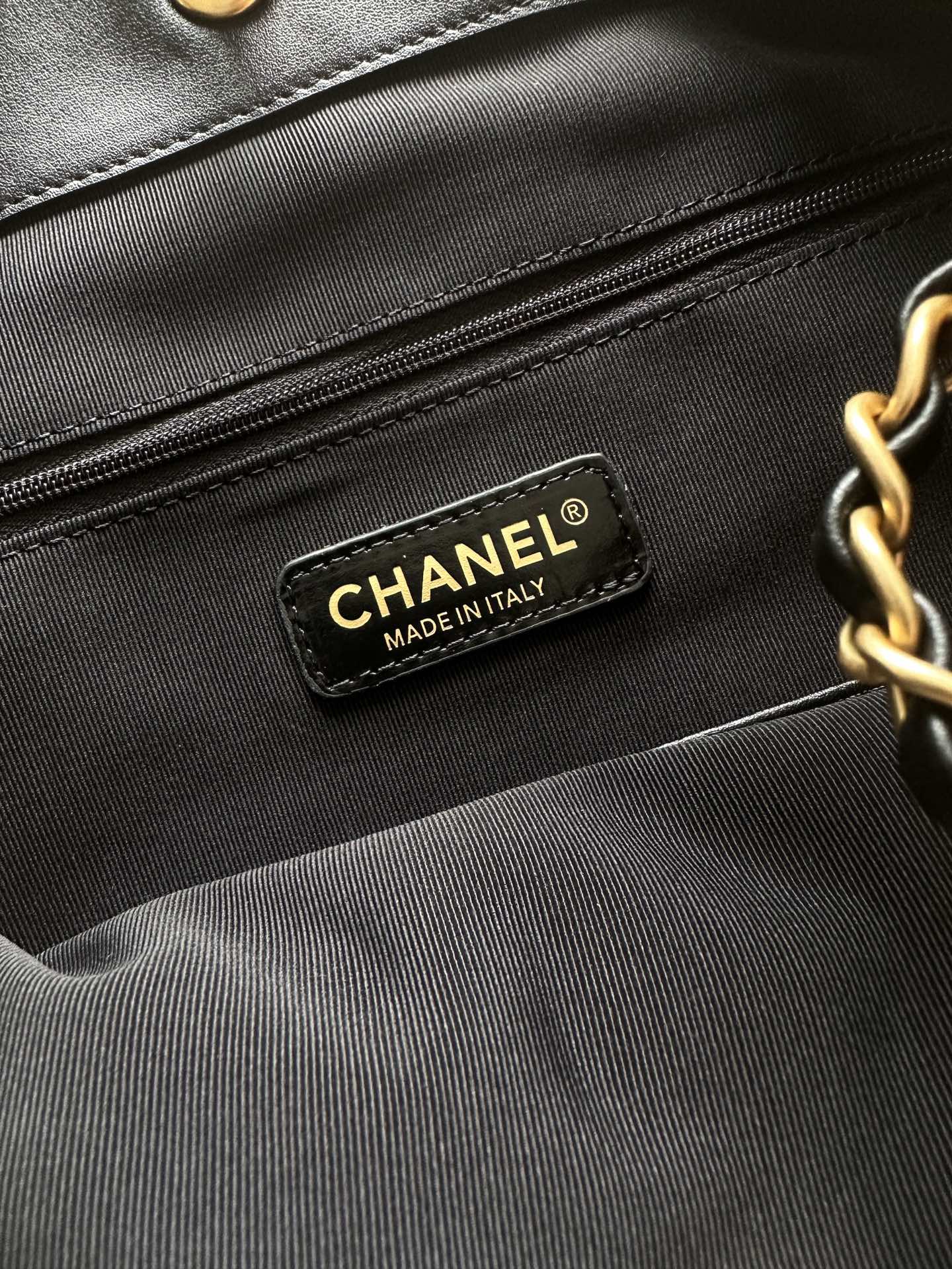 Chanel interior brand label reading CHANEL MADE IN ITALY on black lining