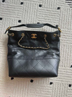 Chanel quilted leather shoulder bag with gold chain handle and CC logo front