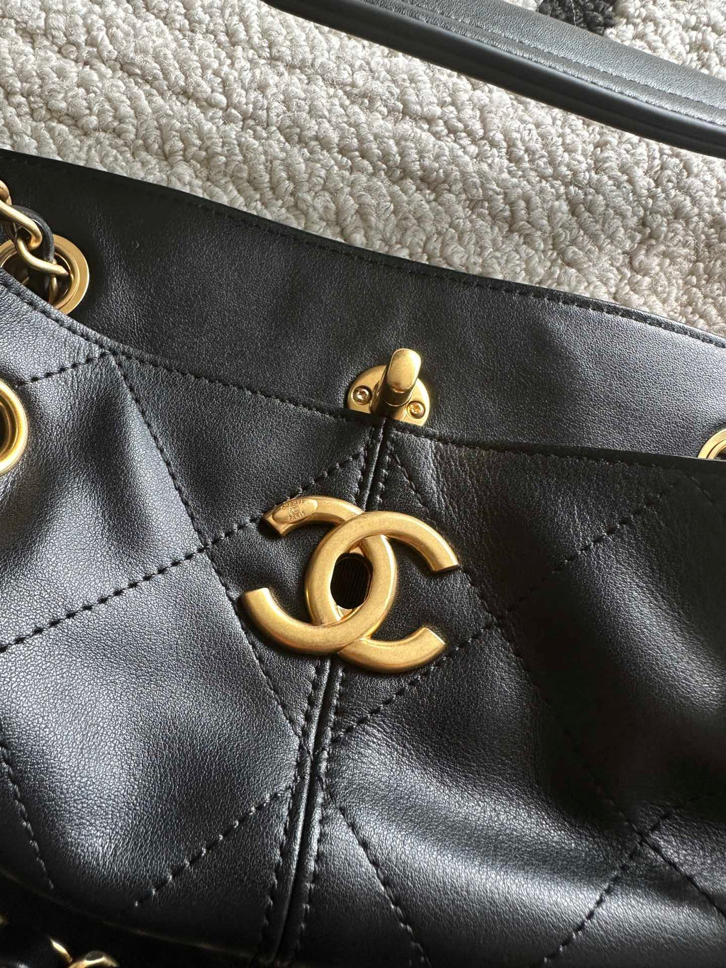 Chanel front CC charm on quilted leather bucket bag with gold hardware