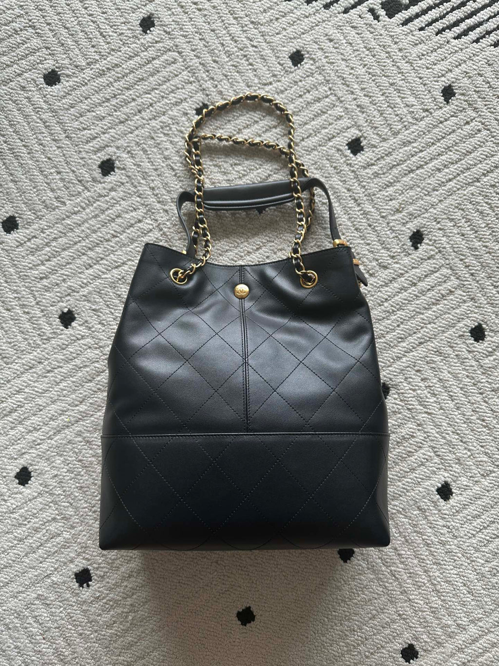 Chanel quilted leather bucket bag with gold chain strap and CC emblem