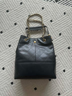 Chanel quilted leather bucket bag with gold chain strap and CC emblem