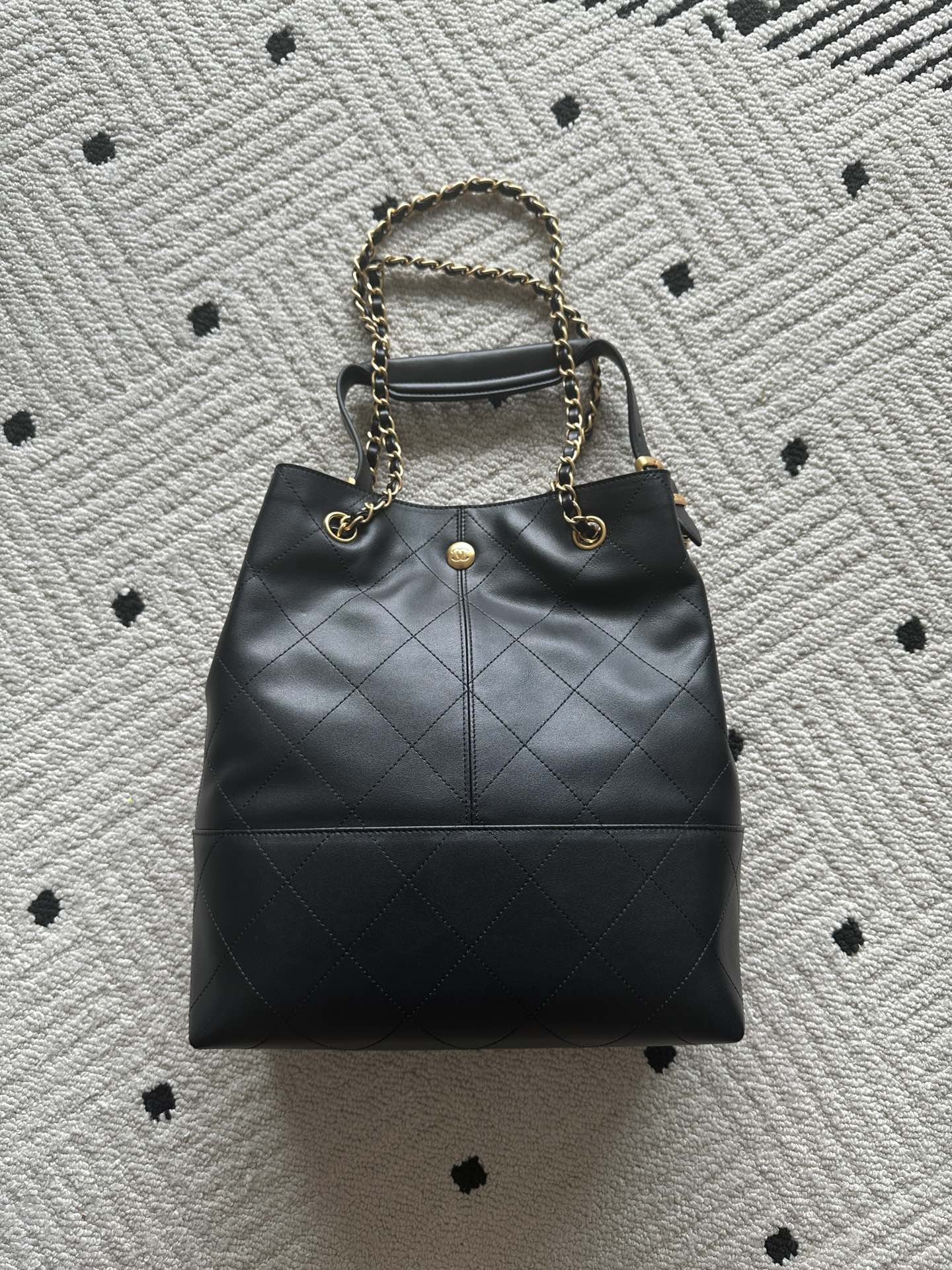 Chanel quilted leather bucket bag with gold chain strap and CC emblem