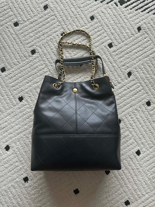Chanel quilted leather bucket bag with gold chain strap and CC emblem