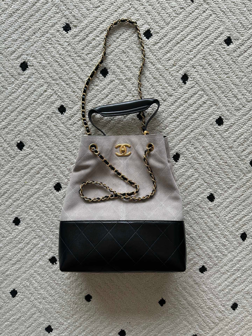 Two-tone tote bag with chain handles; light top, black bottom, gold Chanel hardware