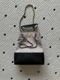 Two-tone tote bag with chain handles; light top, black bottom, gold Chanel hardware