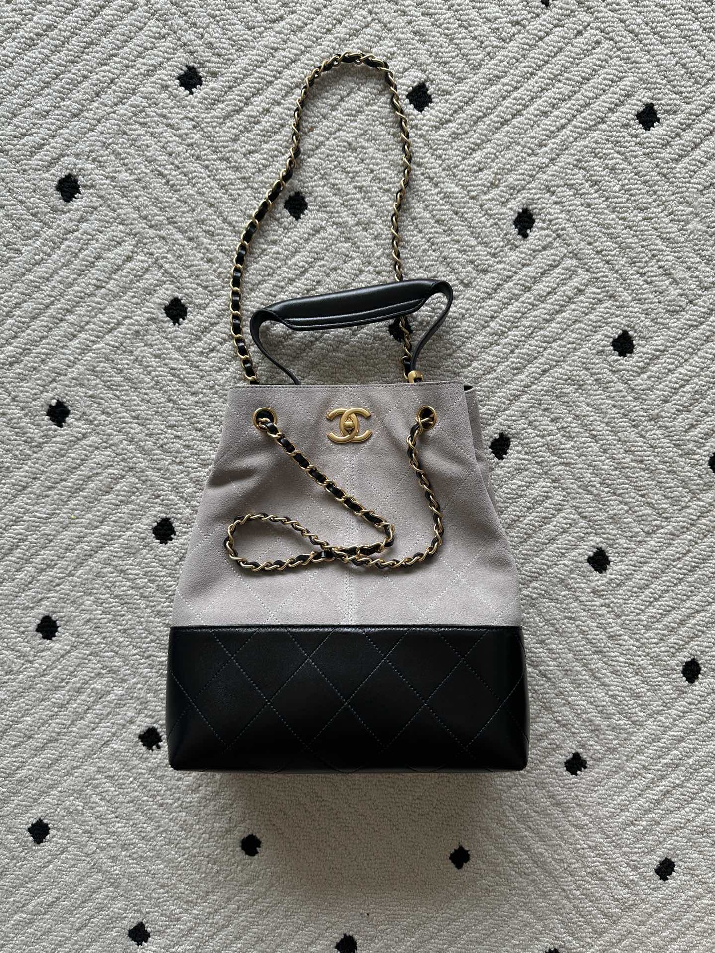 Two-tone tote bag with chain handles; light top, black bottom, gold Chanel hardware