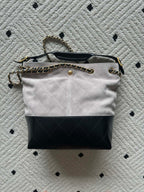 Two-tone shoulder bag with chain strap and top handle; light fabric, black base