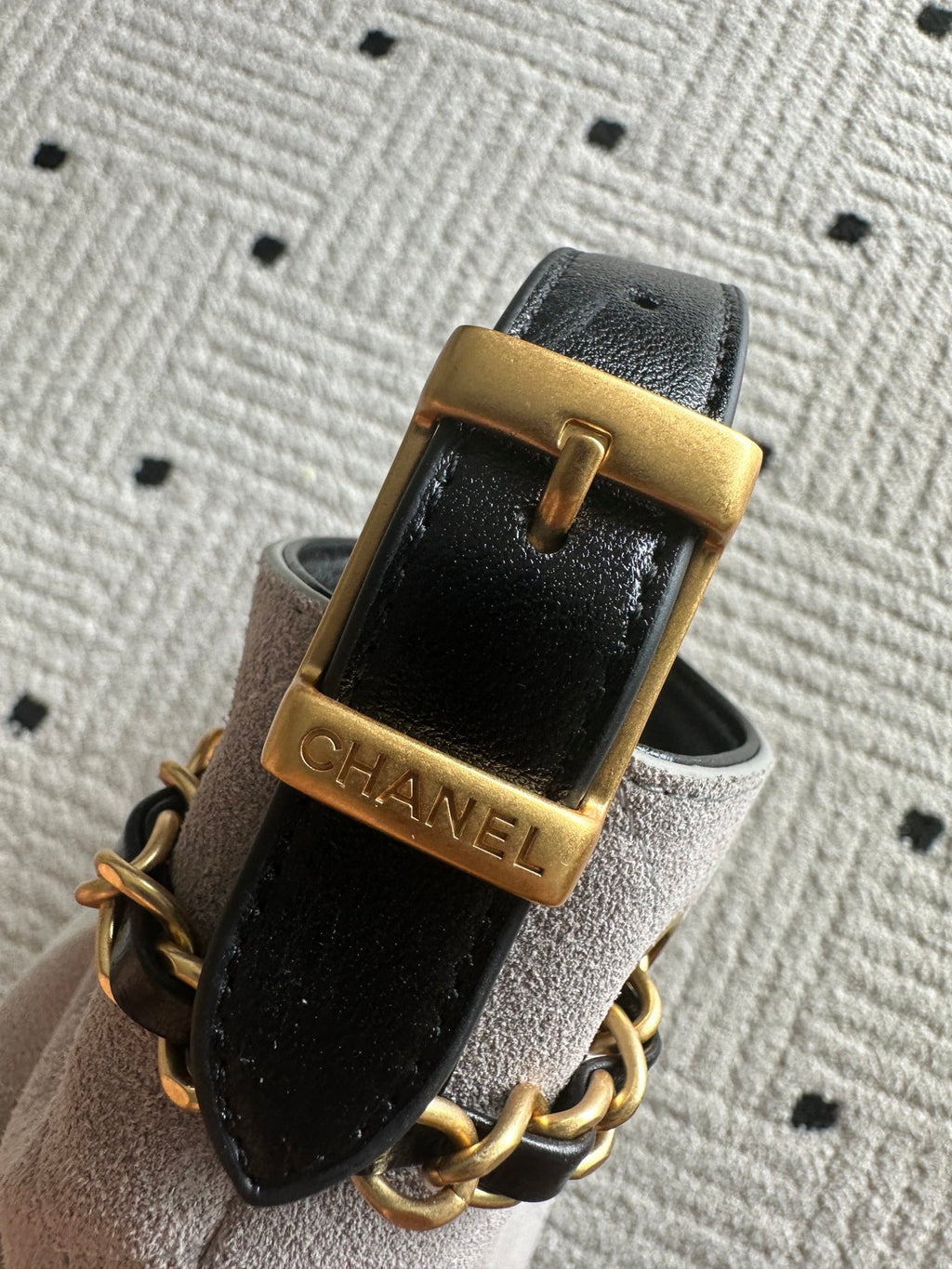 Black leather strap with gold buckle and Chanel engraving, plus chain