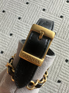 Black leather strap with gold buckle and Chanel engraving, plus chain