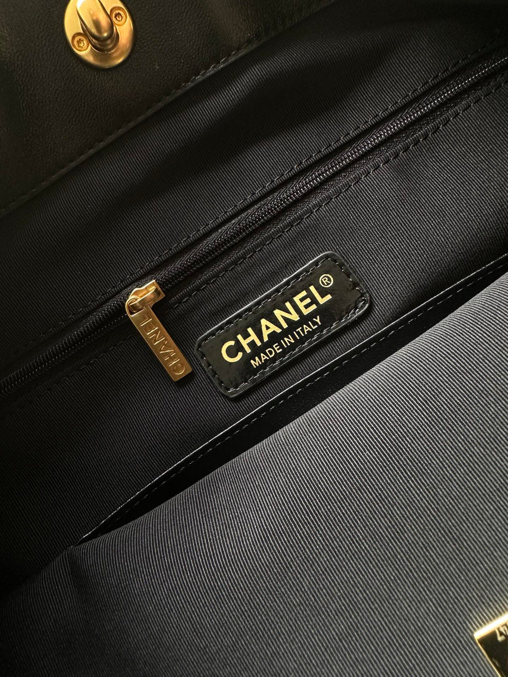 Black interior pocket with Chanel label and gold zipper pull