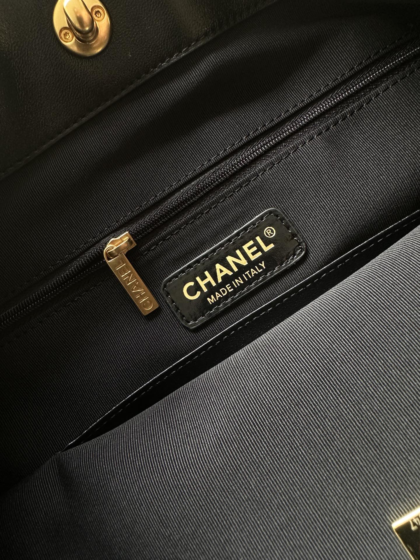 Black interior pocket with Chanel label and gold zipper pull