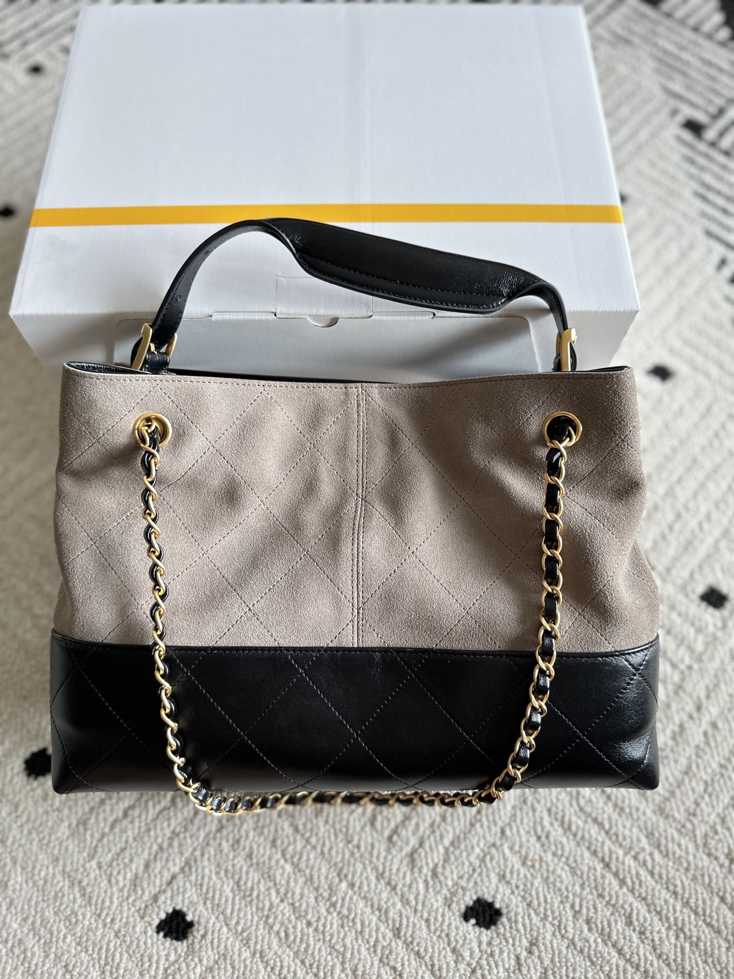 Chanel handbag in taupe and black with quilted center panel, long chain shoulder strap, CC logo.