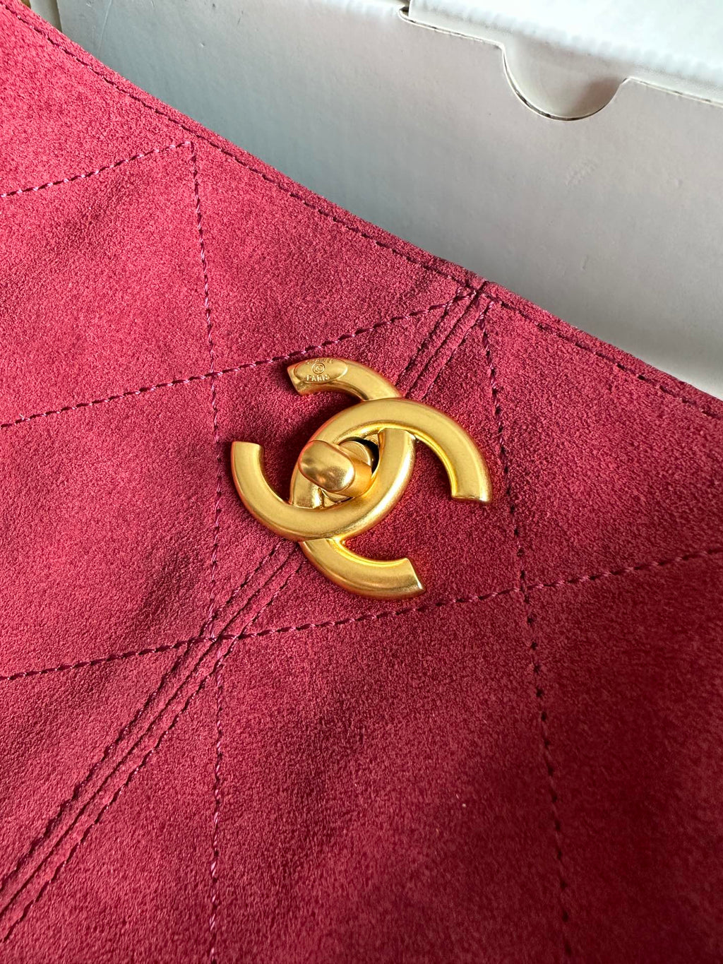 Burgundy handbag front detail with gold-tone double-C logo hardware