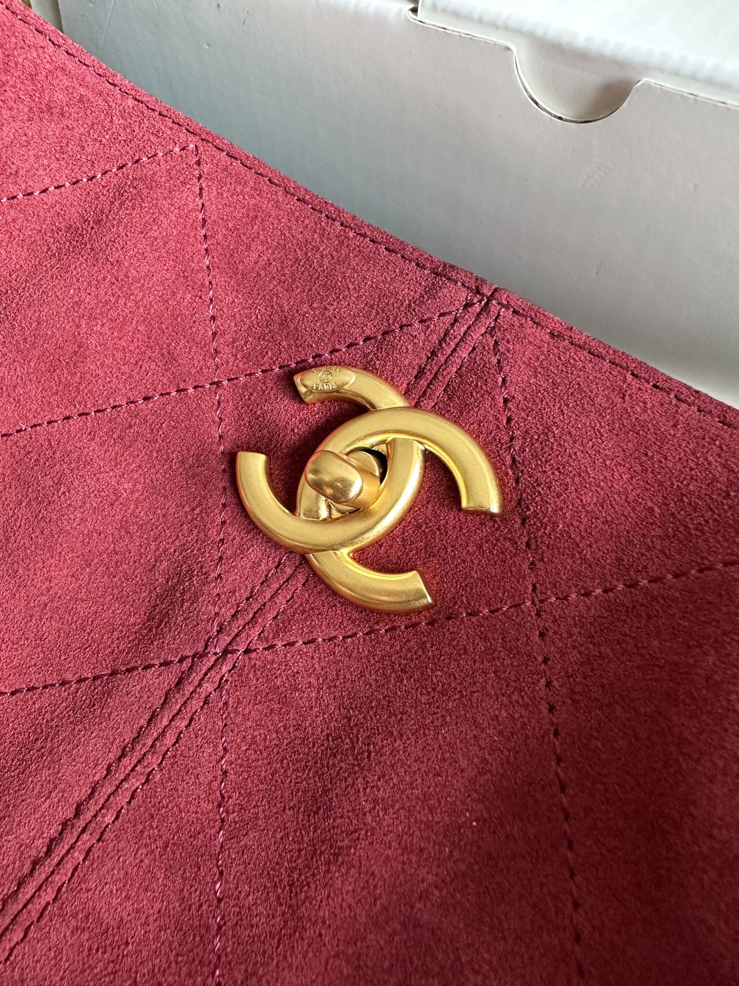 Burgundy handbag front detail with gold-tone double-C logo hardware