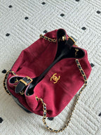 Burgundy and black handbag with gold-tone chain strap and double-C logo front