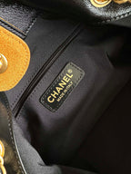Black fabric interior label reading CHANEL and MADE IN ITALY on two-tone bag lining.
