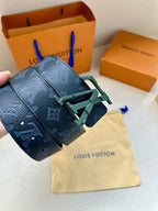 Monogram belt with dark blue strap and green buckle, stitched leather