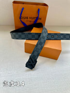 Checked canvas belt laid across gift boxes with LV buckle