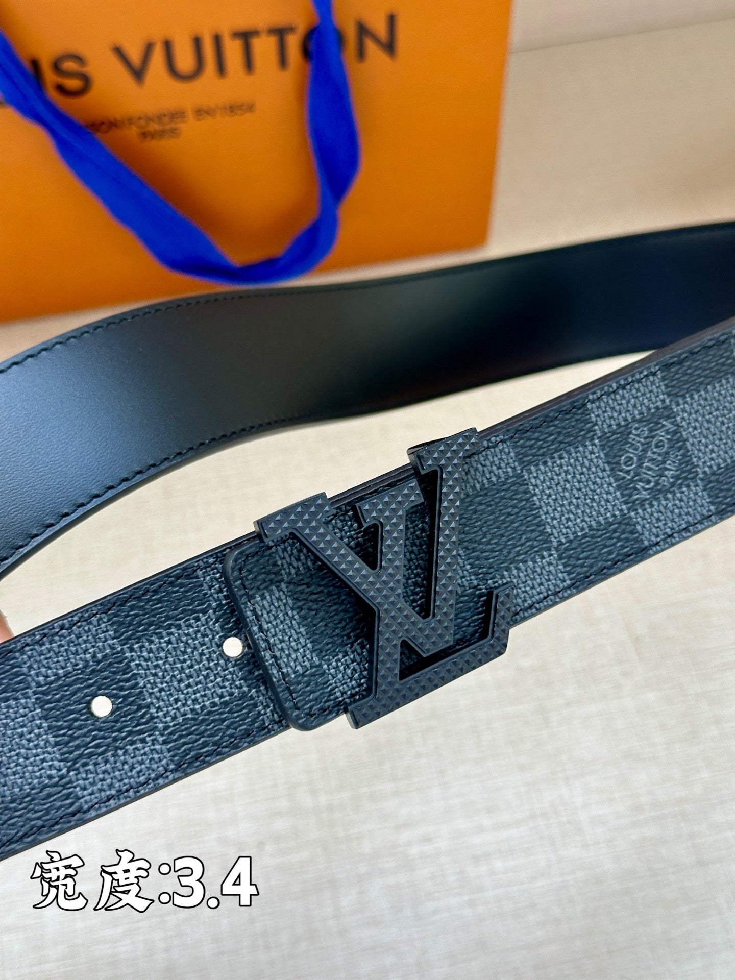Checked strap belt with punched holes and LV-style buckle