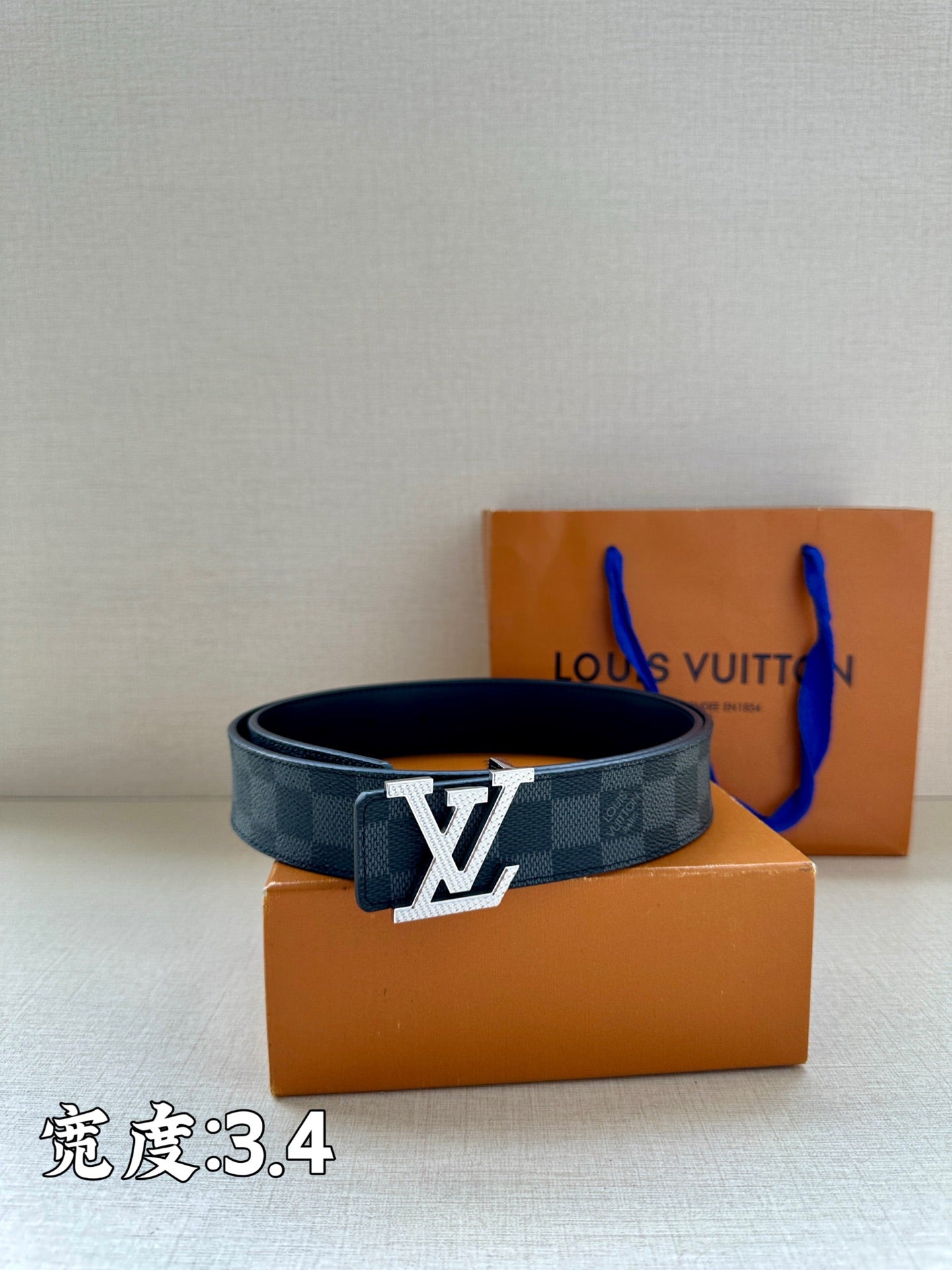 Checked canvas belt with LV buckle on orange gift boxes
