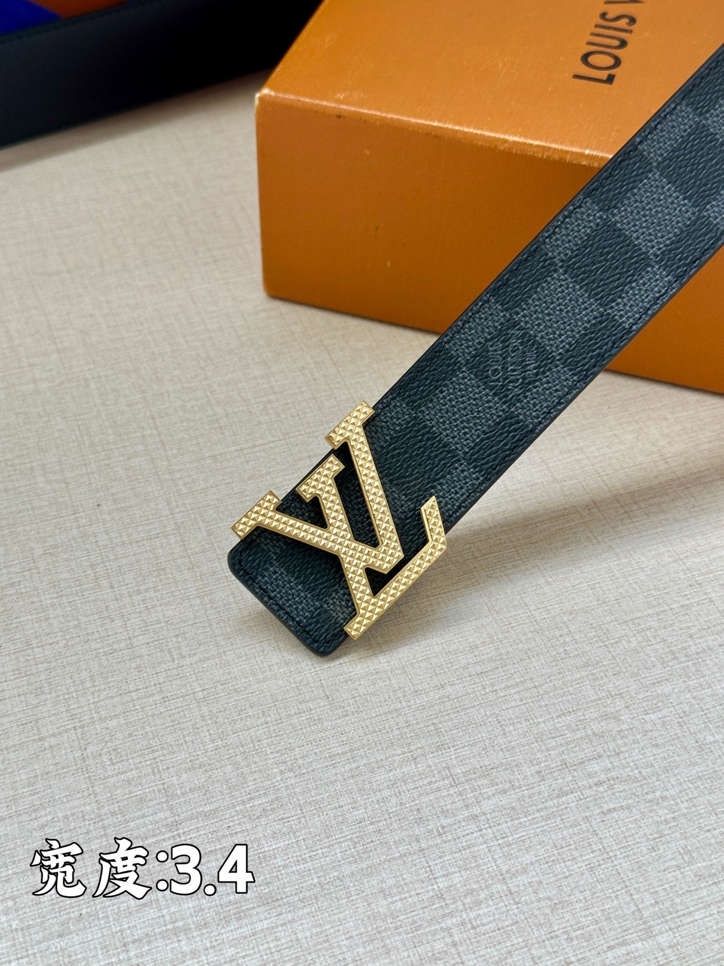 Checked belt with gold-tone LV buckle close-up