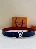 Louis Vuitton belt with navy blue strap and silver LV buckle, displayed on boxes